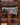 Axe with engraved text on a wooden background with descriptive text about its history.