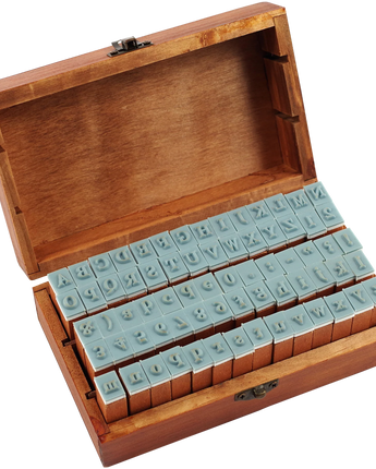 Wooden box with letter stamps on a white background