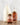 Three maple syrup products on a wooden surface with a light gray background
