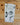 Folded tea towel with Christmas-themed designs on a wooden surface