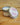 Rosewater & Jasmine scented candle in a metal tin on a wooden surface