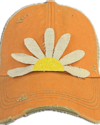 Orange cap with a white daisy design on a white background