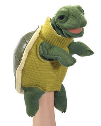 Green turtle puppet with a yellow sweater on a white background