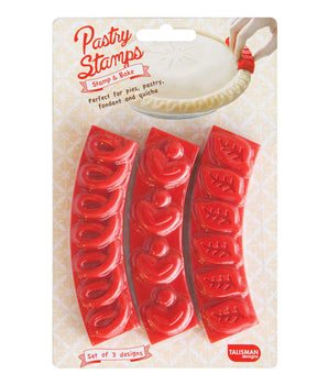 A set of three red pastry stamps with loop, heart, and leaf patterns, packaged in a clear plastic bag with a white cardboard backing.