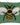 Textured green pillow with a bee design on a white background