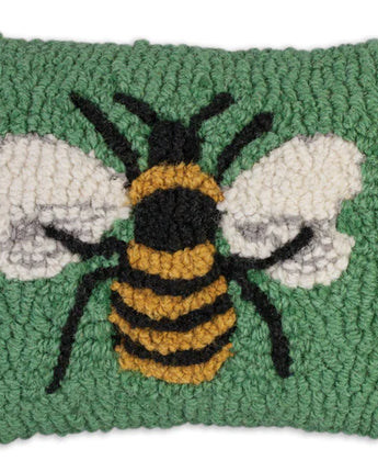 Textured green pillow with a bee design on a white background