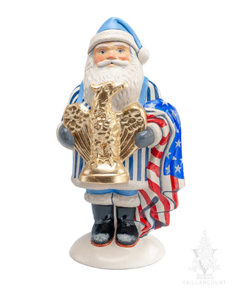 Santa Claus figurine holding a gold eagle emblem and an American flag on a white background