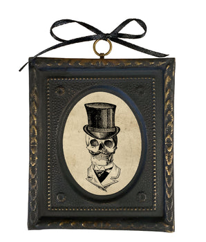 Decorative frame with a skull wearing a top hat design on a white background