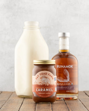 Three maple syrup products on a wooden surface with a light gray background