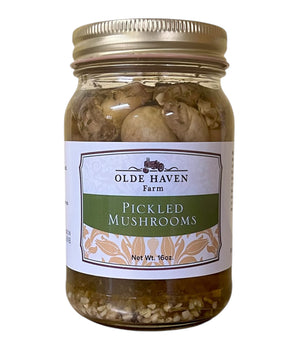Jar of pickled mushrooms with 'Olde Haven Farm' label on a white background