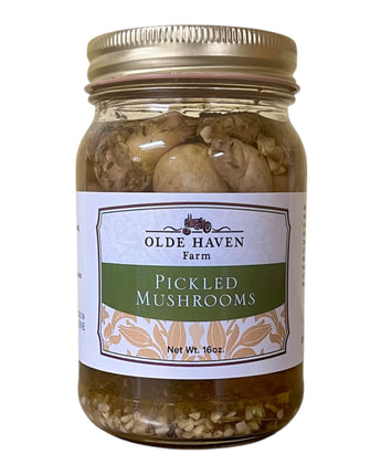 Jar of pickled mushrooms with 'Olde Haven Farm' label on a white background