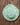 Mint green straw hat with floral embroidery on a wooden surface