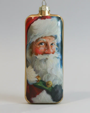 Decorative Christmas ornament with a painted face of Santa Claus on a plain background