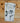 Folded tea towel with Christmas-themed designs on a wooden surface