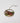 Decorative ornament with a scene of the Miner Grant Store and a fife and drum parade on a white background