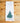 Tea towel with Christmas tree design and text on a wooden surface