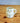White snowman-shaped mug on a wooden surface with a plain background
