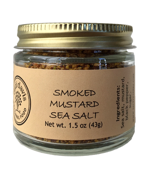 A glass jar containing Smoked Mustard Sea Salt with a label indicating the product name and weight.