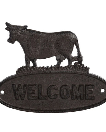 Decorative metal 'Welcome' sign with cow design on a white background