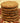 A stack of Old Sturbridge Village Joe Frogger cookies on a brown redware plate.