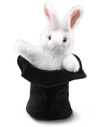 White rabbit puppet inside a black magician's hat on a white background