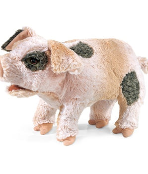 Plush toy pig with black spots on a white background