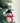 Felt snowman ornament with a black top hat and red scarf hanging on a Christmas tree.
