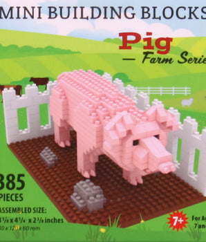 Packaging for Pig Mini Building Blocks with a pink pig figurine in front of a white fence and green field. The box indicates the product is for ages 7 and up, with 385 pieces.